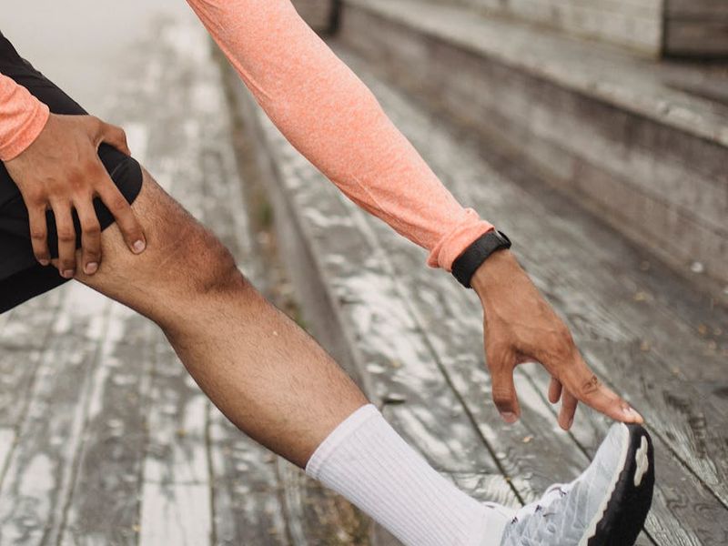 A person performing dynamic stretching exercises in a loft