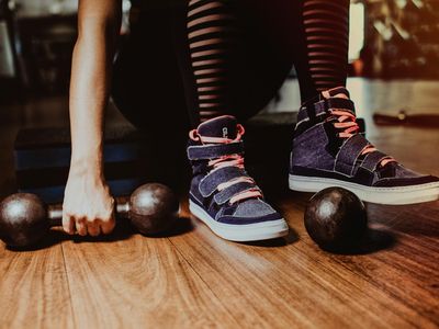 Athletic shoes on a grey floor near gym equipment